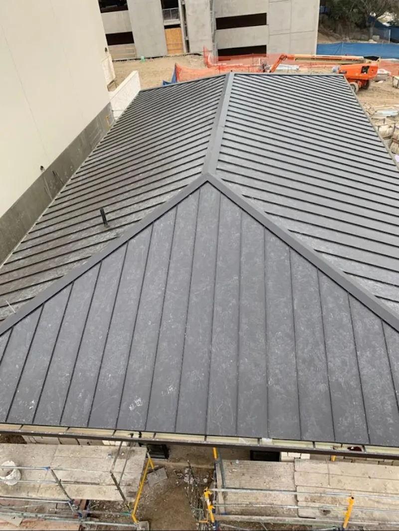 Commercial metal roof construction with crane equipment in Martinsburg